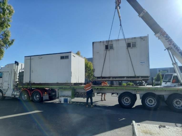 Shed being loaded off a truck