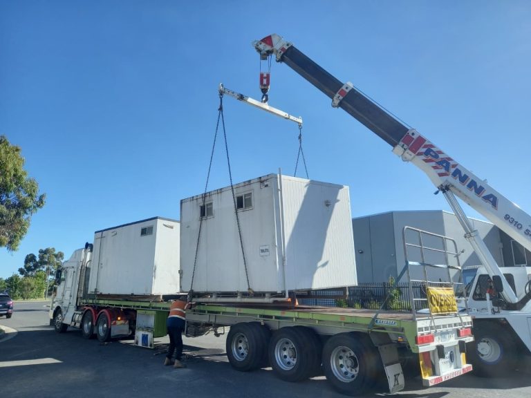 Shed being loaded off a truck